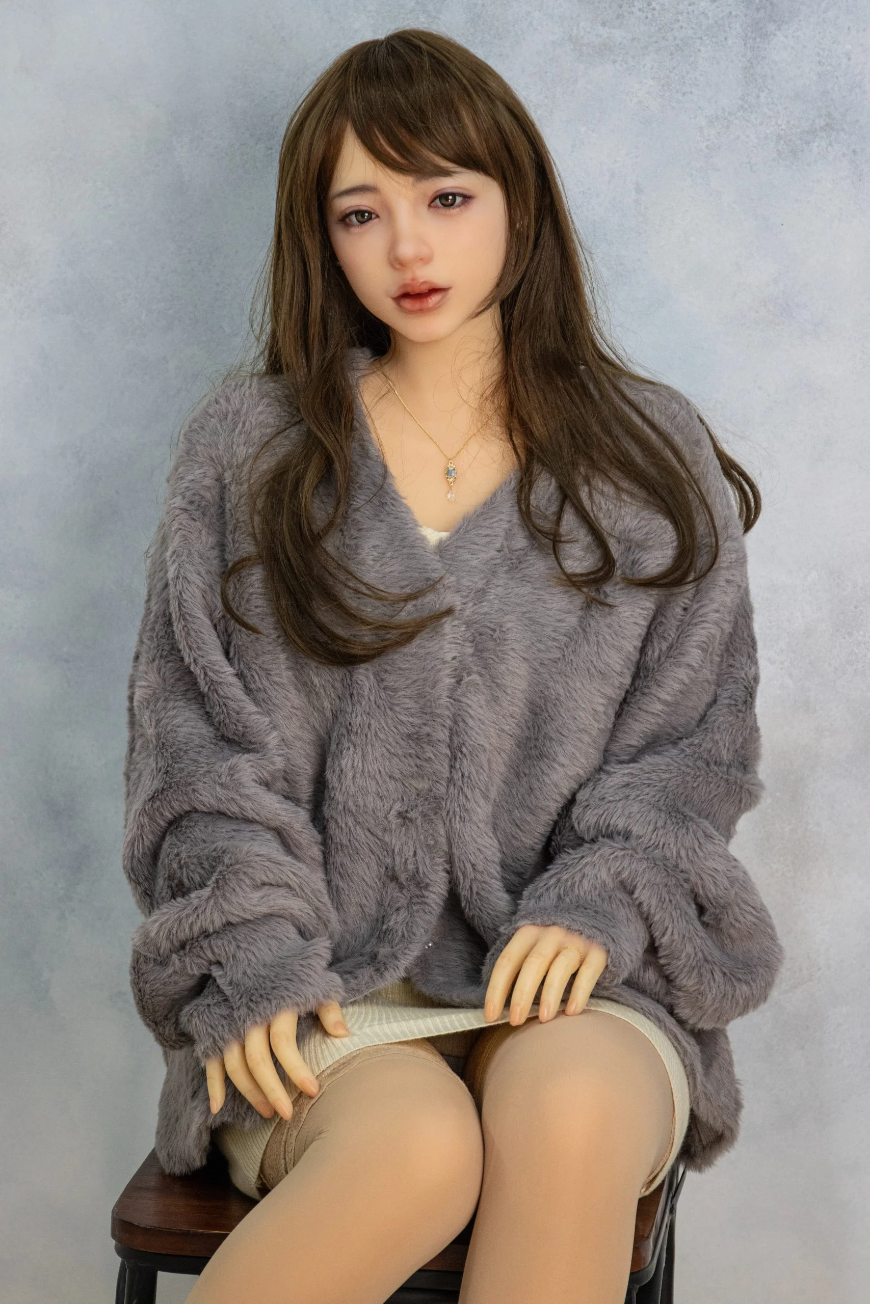 Orient Industry Mei doll from the Yasuragi Series sitting on a chair