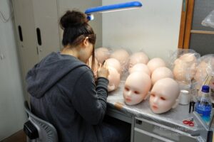 Orient Industry artisan finishing Japanese love doll heads during the manufacturing process