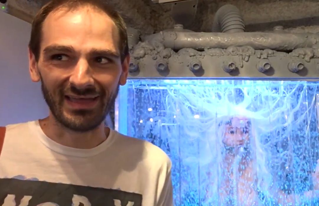 Overseas visitor captivated by a futuristic display of a Japanese love doll